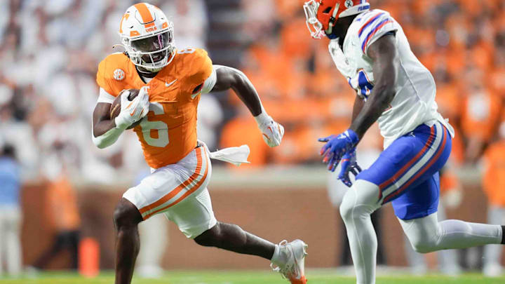 Tennessee running back Dylan Sampson (6) runs the ball while defended by Florida defensive back Jordan Castell (14) during a game between Florida and Tennessee in Neyland Stadium, in Knoxville, Tenn., Saturday, Oct. 12, 2024.