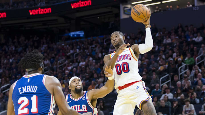 Jan 2, 2025; San Francisco, California, USA; Golden State Warriors forward Jonathan Kuminga (00) passes over Philadelphia 76ers center Joel Embiid (21) and forward Guerschon Yabusele (28) during the third quarter at Chase Center. Mandatory Credit: John Hefti-Imagn Images Jan 2, 2025; San Francisco, California, USA; Golden State Warriors forward Jonathan Kuminga (00) passes over Philadelphia 76ers center Joel Embiid (21) and forward Guerschon Yabusele (28) during the third quarter at Chase Center. Mandatory Credit: John Hefti-Imagn Images