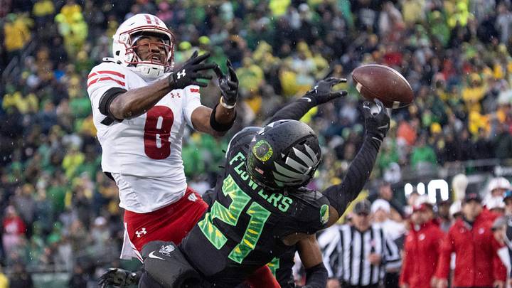 Oregon's Aaron Flowers, right, breaks up a pass intended for Wisconsin’s Vinny Anthony II during the second quarter at Autzen Stadium Oct. 25, 2025.