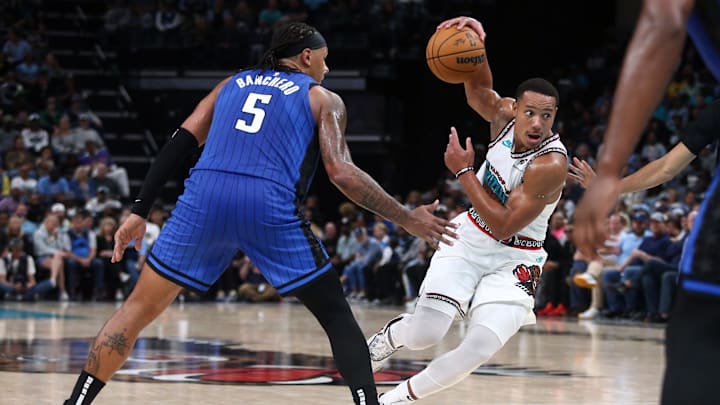 Oct 26, 2024; Memphis, Tennessee, USA; Memphis Grizzlies guard Desmond Bane (22) drives to the basket as Orlando Magic forward Paolo Banchero (5) defends during the second half at FedExForum. Mandatory Credit: Petre Thomas-Imagn Images