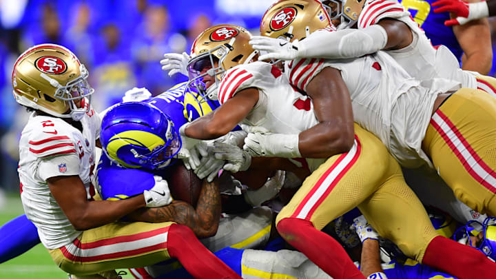 Oct 2, 2025; Inglewood, California, USA; Los Angeles Rams running back Kyren Williams (23) is tackled for no gain on fourth down to end the game against the San Francisco 49ers during overtime at SoFi Stadium. Mandatory Credit: Gary A. Vasquez-Imagn Images