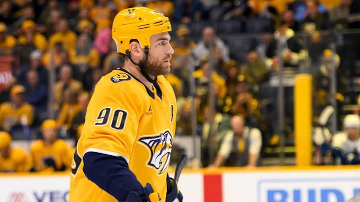 Jan 29, 2025; Nashville, Tennessee, USA;  Nashville Predators center Ryan O'Reilly (90) awaits the face off against the Vancouver Canucks during the second period at Bridgestone Arena. Mandatory Credit: Steve Roberts-Imagn Images