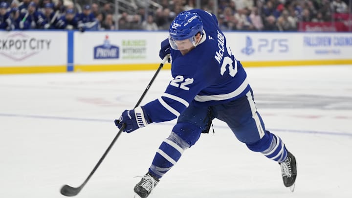 Oct 24, 2024; Toronto, Ontario, CAN; Toronto Maple Leafs defenseman Jake McCabe (22) shoots the puck against the St. Louis Blues during the third period at Scotiabank Arena. Mandatory Credit: John E. Sokolowski-Imagn Images Oct 24, 2024; Toronto, Ontario, CAN; Toronto Maple Leafs defenseman Jake McCabe (22) shoots the puck against the St. Louis Blues during the third period at Scotiabank Arena. Mandatory Credit: John E. Sokolowski-Imagn Images