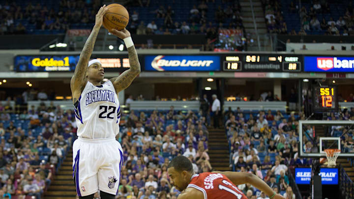 Mar 23, 2014; Sacramento, CA, USA; Sacramento Kings guard Isaiah Thomas (22) scores a three point basket against guard Ramon Sessions (13) during the fourth quarter at Sleep Train Arena. The Sacramento Kings defeated the Milwaukee Bucks 124-107. Mandatory Credit: Kelley L Cox-USA TODAY Sports