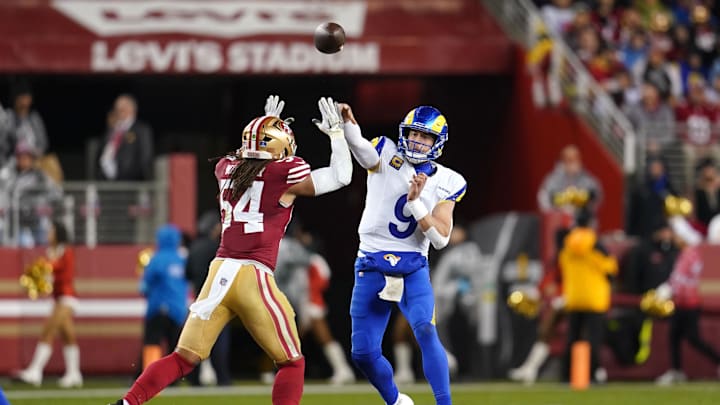 Dec 12, 2024; Santa Clara, California, USA; Los Angeles Rams quarterback Matthew Stafford (9) throws a pass over San Francisco 49ers linebacker Fred Warner (54) in the third quarter at Levi's Stadium. Mandatory Credit: Cary Edmondson-Imagn Images