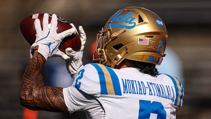 Oct 19, 2024; Piscataway, New Jersey, USA; UCLA Bruins wide receiver Titus Mokiao-Atimalala (2) catches the ball during warm ups before the game against the Rutgers Scarlet Knights at SHI Stadium. Mandatory Credit: Vincent Carchietta-Imagn Images Oct 19, 2024; Piscataway, New Jersey, USA; UCLA Bruins wide receiver Titus Mokiao-Atimalala (2) catches the ball during warm ups before the game against the Rutgers Scarlet Knights at SHI Stadium. Mandatory Credit: Vincent Carchietta-Imagn Images