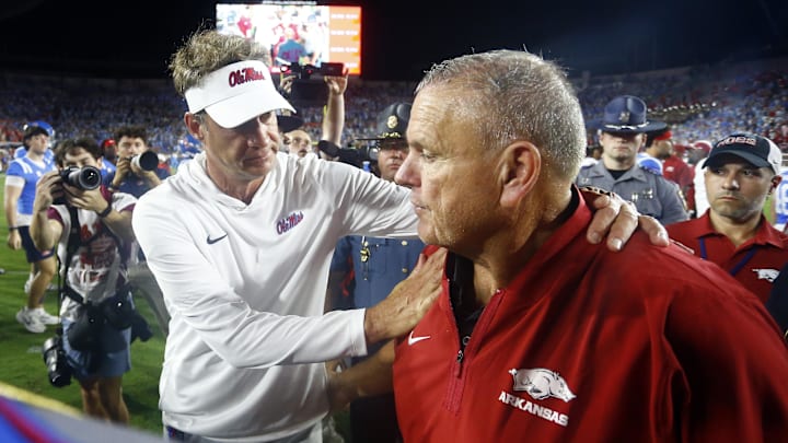 Sep 13, 2025; Oxford, Mississippi, USA; Mississippi Rebels head coach Lane Kiffin (left) and Arkansas Razorback head coach Sam Pittman (right) embrace after the game  at Vaught-Hemingway Stadium. Mandatory Credit: Petre Thomas-Imagn Images