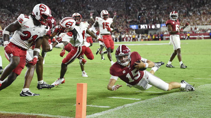 Aug 31, 2024; Tuscaloosa, Alabama, USA;  Alabama Crimson Tide quarterback Ty Simpson (15) attempts to dive for the pylon as he runs the ball at Bryant-Denny Stadium with Western Kentucky Hilltoppers linebacker Anthony Brackenridge (31) pursuing. Alabama defeated Western Kentucky 63-0. Mandatory Credit: Gary Cosby Jr.-Imagn Images