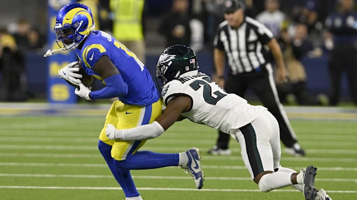 Nov 24, 2024; Inglewood, California, USA;  Los Angeles Rams wide receiver Tyler Johnson (18) is stopped by Philadelphia Eagles cornerback Quinyon Mitchell (27) after a catch during the second half at SoFi Stadium. Mandatory Credit: Alex Gallardo-Imagn Images