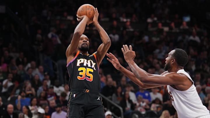 Mar 21, 2025; Phoenix, Arizona, USA; Phoenix Suns forward Kevin Durant (35) shoots against Cleveland Cavaliers forward Evan Mobley (4) during the second half at Footprint Center. Mandatory Credit: Joe Camporeale-Imagn Images