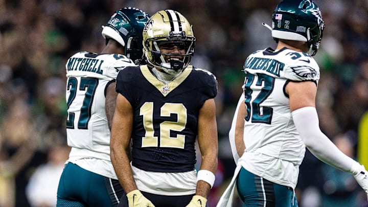 Sep 22, 2024; New Orleans, Louisiana, USA; New Orleans Saints wide receiver Chris Olave (12) reacts to making a first down reception against Philadelphia Eagles safety Reed Blankenship (32) during the first half at Caesars Superdome. Mandatory Credit: Stephen Lew-Imagn Images
