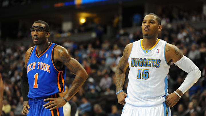 Nov 16, 2010; Denver, CO, USA; New York Knicks power forward Amare Stoudemire (1) and Denver Nuggets small forward Carmelo Anthony (15) await a free throw to be completed in the fourth quarter at the Pepsi Center. The Nuggets defeated the Knicks 120-118. Mandatory Credit: Ron Chenoy-Imagn Images