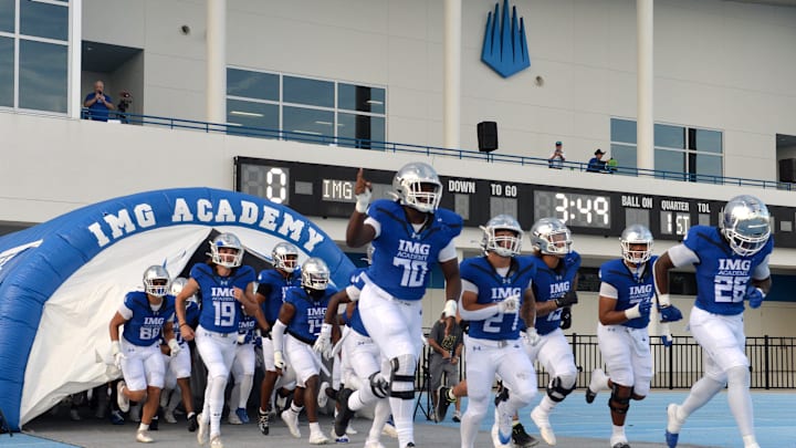 IMG Academy players run onto the field. The IMG Academy National squad hosted the Cocoa High School Tigers Friday, Sept. 6, 2024 in Bradenton.