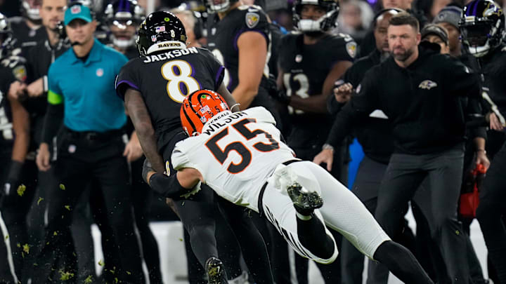 Baltimore Ravens quarterback Lamar Jackson (8) is pulled down by Cincinnati Bengals linebacker Logan Wilson (55) in the first quarter of the NFL Week 11 game between the Baltimore Ravens and the Cincinnati Bengals at M&T Bank Stadium in Baltimore on Thursday, Nov. 16, 2023.