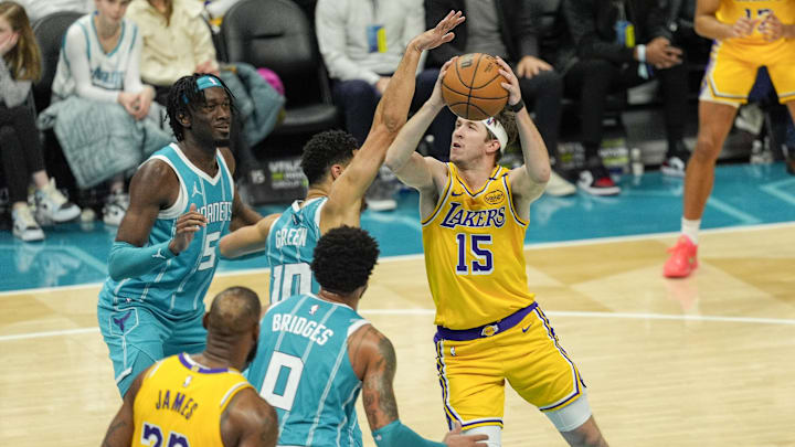 Jan 27, 2025; Charlotte, North Carolina, USA; Los Angeles Lakers guard Austin Reaves (15) drives to the basket against Charlotte Hornets guard Josh Green (10) during the second quarter at the Spectrum Center. Mandatory Credit: Jim Dedmon-Imagn Images