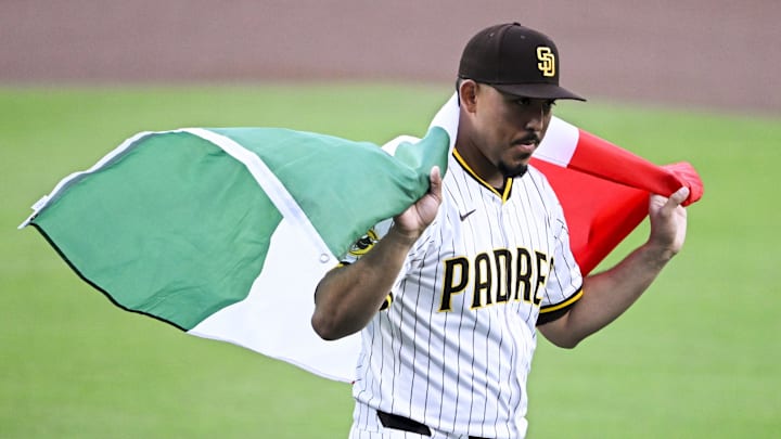 Sep 27, 2025; San Diego, California, USA; San Diego Padres relief pitcher Jeremiah Estrada (56) walks off the field draped in a Mexican flag after a ceremony held for Hispanic Heritage Weekend at Petco Park. Mandatory Credit: Denis Poroy-Imagn Images Sep 27, 2025; San Diego, California, USA; San Diego Padres relief pitcher Jeremiah Estrada (56) walks off the field draped in a Mexican flag after a ceremony held for Hispanic Heritage Weekend at Petco Park. Mandatory Credit: Denis Poroy-Imagn Images