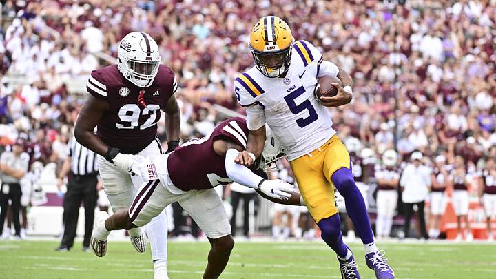 LSU Tigers quarterback Jayden Daniels (5) runs the ball for a touchdown while defended by Mississippi State Bulldogs safety Isaac Smith (20) during the third quarter at Davis Wade Stadium at Scott Field. LSU Tigers quarterback Jayden Daniels (5) runs the ball for a touchdown while defended by Mississippi State Bulldogs safety Isaac Smith (20) during the third quarter at Davis Wade Stadium at Scott Field.