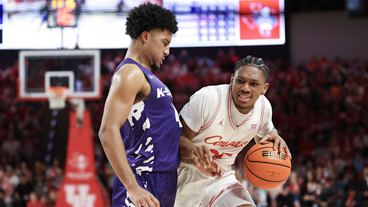 Feb 14, 2026; Houston, Texas, USA; Houston Cougars forward Chase McCarty (24) dribbles against Kansas State Wildcats guard PJ Haggerty (4)  in the first half at Fertitta Center. 