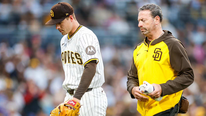 Jun 24, 2025; San Diego, California, USA; San Diego Padres starting pitcher Ryan Bergert (38) walks off the field with San Diego Padres medical staff after being hit by a line drive during the fourth inning against the Washington Nationals at Petco Park. Mandatory Credit: David Frerker-Imagn Images