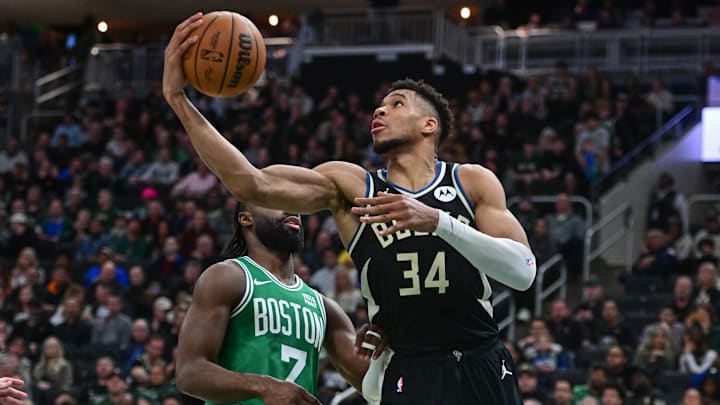 Apr 9, 2024; Milwaukee, Wisconsin, USA; Milwaukee Bucks forward Giannis Antetokounmpo (34) takes a shot against Boston Celtics forward Jaylen Brown (7) in the second quarter at Fiserv Forum. Mandatory Credit: Benny Sieu-Imagn Images
