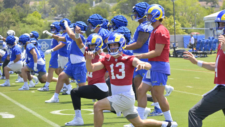 May 28, 2024; Thousand Oaks, CA, USA; Los Angeles Rams quarterbacks Jimmy Garoppolo (11), Stetson Bennett (13) and Matthew Stafford (9) stretch during OTAs at the team training facility at California Lutheran University. Mandatory Credit: Jayne Kamin-Oncea-USA TODAY Sports