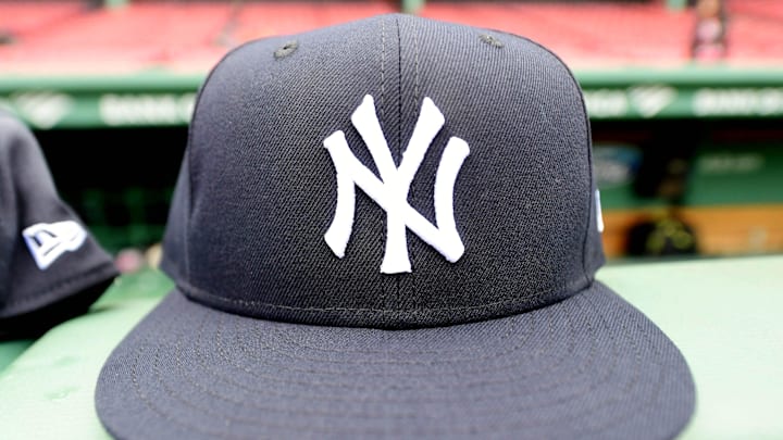 Jun 14, 2025; Boston, Massachusetts, USA; A general view of a New York Yankees cap on the dugout railing prior to a game against the Boston Red Sox at Fenway Park. Mandatory Credit: Bob DeChiara-Imagn Images