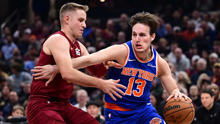 Apr 2, 2025; Cleveland, Ohio, USA;  New York Knicks guard Tyler Kolek (13) drives to the basket against Cleveland Cavaliers guard Sam Merrill (5) during the first half at Rocket Arena. Mandatory Credit: Ken Blaze-Imagn Images