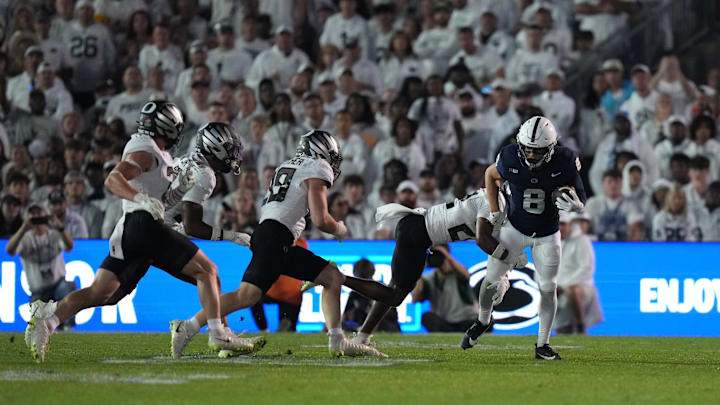 Penn State Nittany Lions wide receiver Trebor Pena (8) is tackled by Oregon Ducks defensive back Peyton Woodyard (12) during the first quarter at Beaver Stadium. 