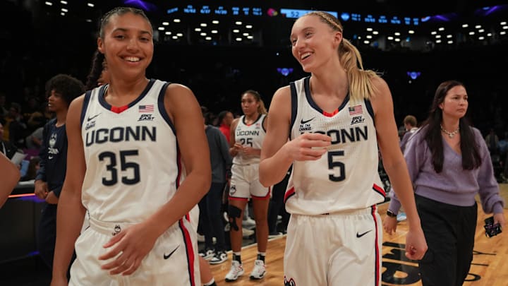 Dec 7, 2024; Brooklyn, New York, USA; Connecticut Huskies guard Azzi Fudd (35) and Connecticut Huskies guard Paige Bueckers (5) celebrate after the game against the Louisville Cardinals at Barclays Center. Mandatory Credit: Lucas Boland-Imagn Images