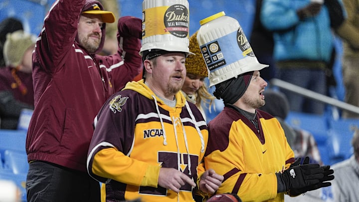 Jan 3, 2025; Charlotte, NC, USA; Minnesota Golden Gophers fans wearing their Dukes hats during the second half against the Virginia Tech Hokies at the Duke’s Mayo Bowl at Bank of America Stadium. Mandatory Credit: Jim Dedmon-Imagn Images Jan 3, 2025; Charlotte, NC, USA; Minnesota Golden Gophers fans wearing their Dukes hats during the second half against the Virginia Tech Hokies at the Duke’s Mayo Bowl at Bank of America Stadium. Mandatory Credit: Jim Dedmon-Imagn Images