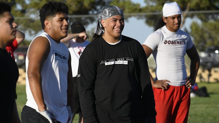 Oak Hills' Sione Felila, center, and Rudy DeLaFuente share a laugh during a recent summer practice at the school.