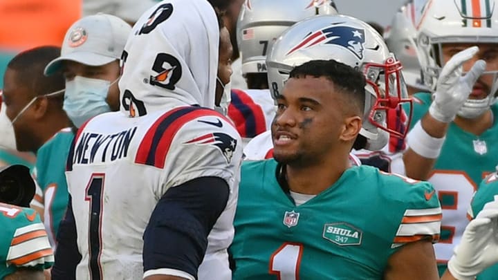 Dec 20, 2020; Miami Gardens, Florida, USA; New England Patriots quarterback Cam Newton (1) and Miami Dolphins quarterback Tua Tagovailoa (1) meet up midfield after the Miami Dolphins defeated the New England Patriots at Hard Rock Stadium.