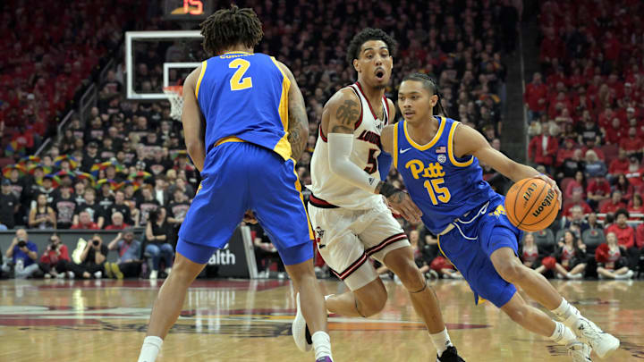 Mar 1, 2025; Louisville, Kentucky, USA;  Pittsburgh Panthers guard Jaland Lowe (15) dribbles against Louisville Cardinals guard Terrence Edwards Jr. (5) during the first half at KFC Yum! Center. Mandatory Credit: Jamie Rhodes-Imagn Images