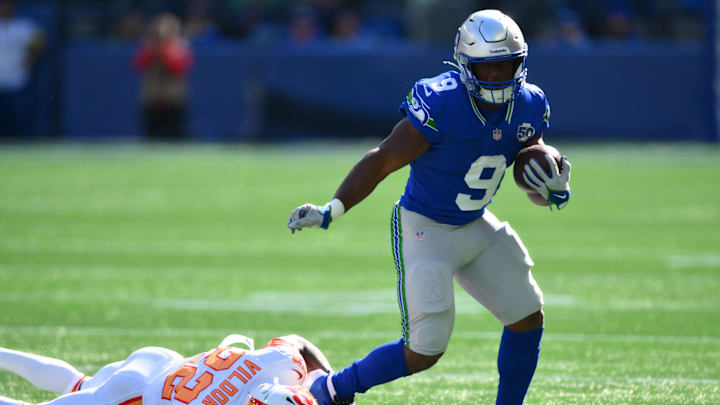 Oct 5, 2025; Seattle, Washington, USA; Seattle Seahawks running back Kenneth Walker III (9) carries the ball as. Tampa Bay Buccaneers cornerback Kindle Vildor (22) defends during the first half at Lumen Field. Mandatory Credit: Steven Bisig-Imagn Images
