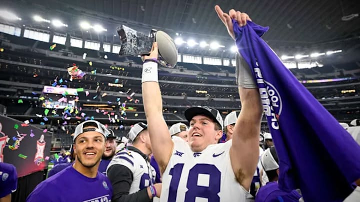 Will Howard (18) holds a t-shirt and a trophy after winning the 2022 Big 12 Championship against the TCU Horned Frogs in Dallas at AT&T Stadium on Dec. 3, 2022. Mandatory Credit: Jerome Miron-USA Today Sports.