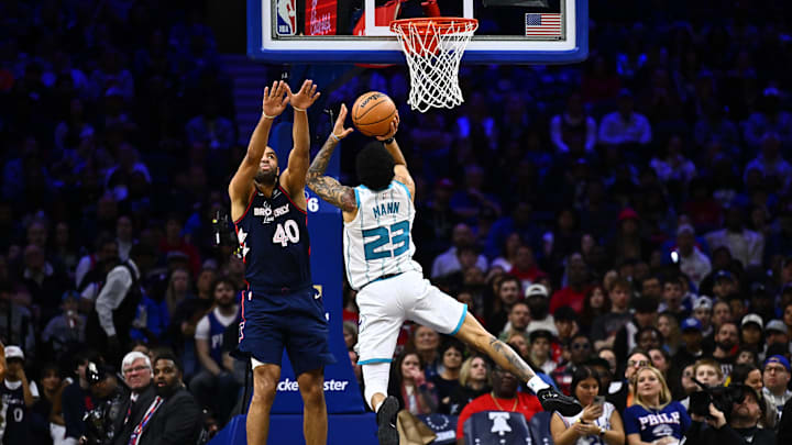 Mar 16, 2024; Philadelphia, Pennsylvania, USA; Charlotte Hornets guard Tre Mann (23) shoots against Philadelphia 76ers forward Nicolas Batum (40) in the first quarter at Wells Fargo Center. Mandatory Credit: Kyle Ross-Imagn Images