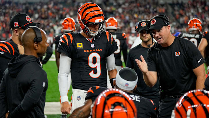Cincinnati Bengals quarterback Joe Burrow (9) and head coach Zac Taylor talk with wide receiver Ja'Marr Chase (1) on the bench after a drive in the fourth quarter of the NFL Week 3 game between the Cincinnati Bengals and the Washington Commanders at Paycor Stadium in downtown Cincinnati on Monday, Sept. 23, 2024. The Bengals remain winless after a 38-33 loss to Washington.