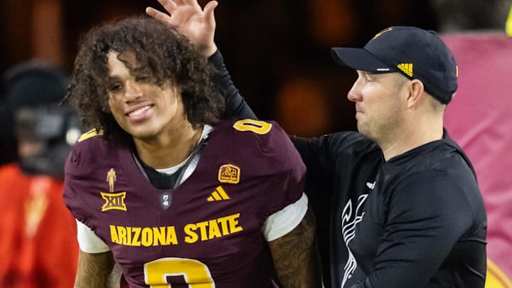 Nov 28, 2025; Tempe, Arizona, USA; Arizona State Sun Devils wide receiver Jordyn Tyson (0) with head coach Kenny Dillingham against the Arizona Wildcats during the 99th Territorial Cup at Mountain America Stadium. Mandatory Credit: Mark J. Rebilas-Imagn Images Nov 28, 2025; Tempe, Arizona, USA; Arizona State Sun Devils wide receiver Jordyn Tyson (0) with head coach Kenny Dillingham against the Arizona Wildcats during the 99th Territorial Cup at Mountain America Stadium. Mandatory Credit: Mark J. Rebilas-Imagn Images
