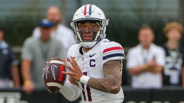 Nov 2, 2024; Orlando, Florida, USA; Arizona Wildcats quarterback Noah Fifita (11) rolls out to pass against the UCF Knights during the second quarter at FBC Mortgage Stadium. Mandatory Credit: Mike Watters-Imagn Images