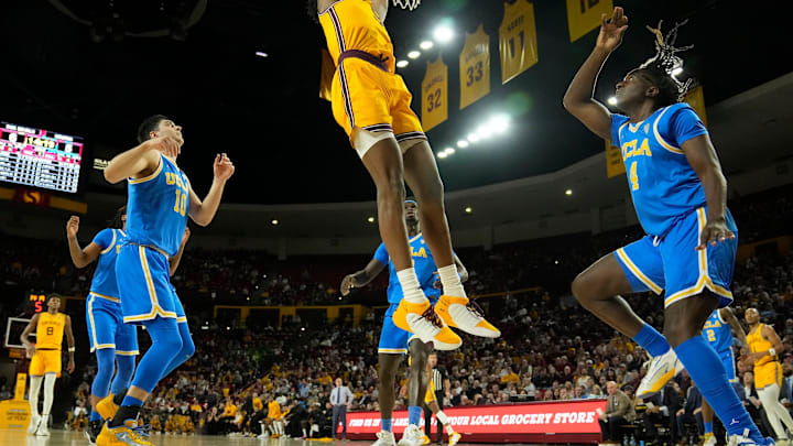 Arizona State Sun Devils center Shawn Phillips Jr. slams two between UCLA Bruins guards Lazar Stefanovic and Will McClendon.