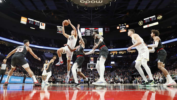 Dec 14, 2023; Portland, Oregon, USA; Utah Jazz forward Simone Fontecchio (16) shoots the ball over Portland Trail Blazers shooting guard Shaedon Sharpe (17) during the first half at Moda Center. Mandatory Credit: Soobum Im-Imagn Images