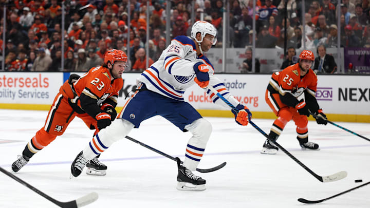 Apr 24, 2026; Anaheim, California, USA;  Edmonton Oilers defenseman Darnell Nurse (25) shoots the puck ahead of Anaheim Ducks center Mason McTavish (23) during the first period of game three of the first round of the 2026 Stanley Cup Playoffs at Honda Center. Mandatory Credit: Kiyoshi Mio-Imagn Images