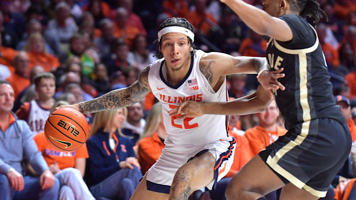Mar 7, 2025; Champaign, Illinois, USA;  Illinois Fighting Illini guard Tre White (22) drives the ball against Purdue Boilermakers guard C.J. Cox (0) during the first half at State Farm Center. Mandatory Credit: Ron Johnson-Imagn Images