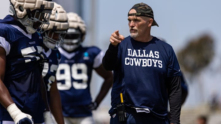 Aug 4, 2022; Oxnard, CA, USA; Dallas Cowboys defensive coordinator Dan Quinn talks to players during training camp at River Ridge Playing Fields in Oxnard, California. Mandatory Credit: Jason Parkhurst-Imagn Images