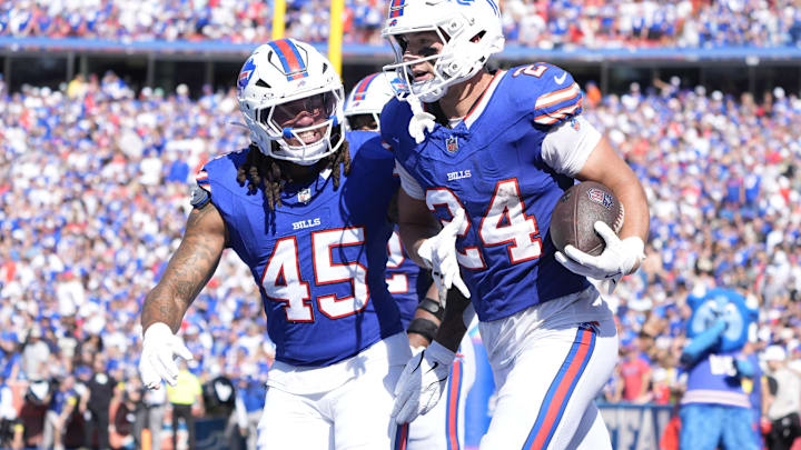 Buffalo Bills safety Cole Bishop and outside linebacker Shaq Thompson celebrate after an interception.
