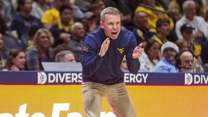 Dec 22, 2025; Morgantown, West Virginia, USA; West Virginia Mountaineers head coach Ross Hodge claps during the first half against the Mississippi Valley State Delta Devils at Hope Coliseum.