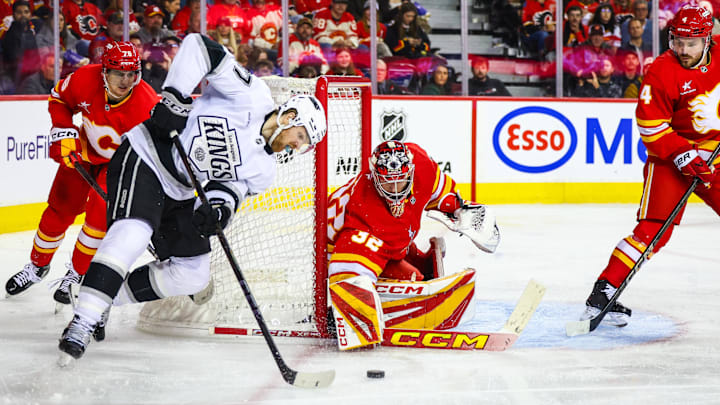 Nov 11, 2024; Calgary, Alberta, CAN; Calgary Flames goaltender Dustin Wolf (32) guards his net against Los Angeles Kings left wing Warren Foegele (37) during the third period at Scotiabank Saddledome. Mandatory Credit: Sergei Belski-Imagn Images