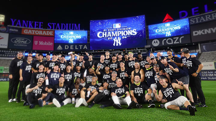 Sep 26, 2024; Bronx, New York, USA; New York Yankees pose for a photo in front of the main scoreboard after defeating the Baltimore Orioles to clinch the American League East division title at Yankee Stadium. Mandatory Credit: Vincent Carchietta-Imagn Images