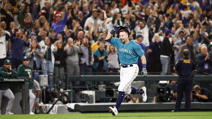 Fans cheer as Seattle Mariners catcher Cal Raleigh (29) runs the bases following his walk-off solo-home run against the Oakland Athletics during the ninth inning at T-Mobile Park. Seattle defeated Oakland 2-1, clinching a wild card playoff berth to end a 21-year playoff drought in 2022.