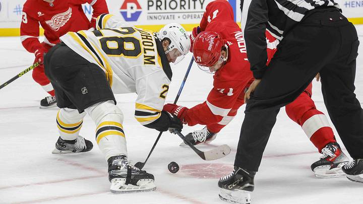 Nov 23, 2024; Detroit, Michigan, USA; Boston Bruins center Elias Lindholm (28) faces off against Detroit Red Wings center Dylan Larkin (71) during the second period of the game at Little Caesars Arena. Mandatory Credit: Brian Bradshaw Sevald-Imagn Images